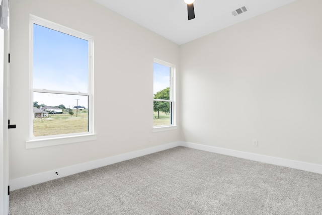 empty room featuring carpet, ceiling fan, and vaulted ceiling