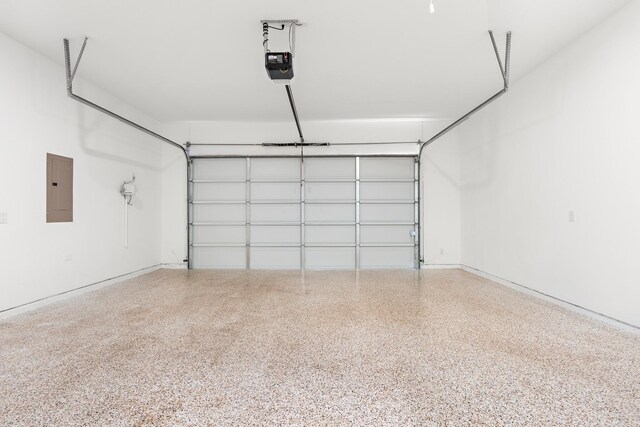 garage featuring a garage door opener and electric panel