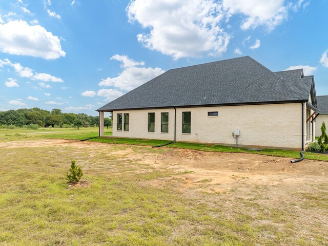 view of side of home featuring a lawn