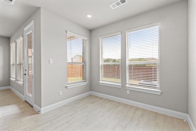 spare room featuring light hardwood / wood-style floors