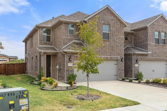 view of front property featuring a garage and a front lawn