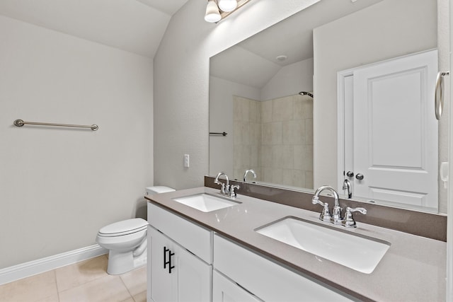 bathroom featuring toilet, tile patterned flooring, vanity, a tile shower, and vaulted ceiling