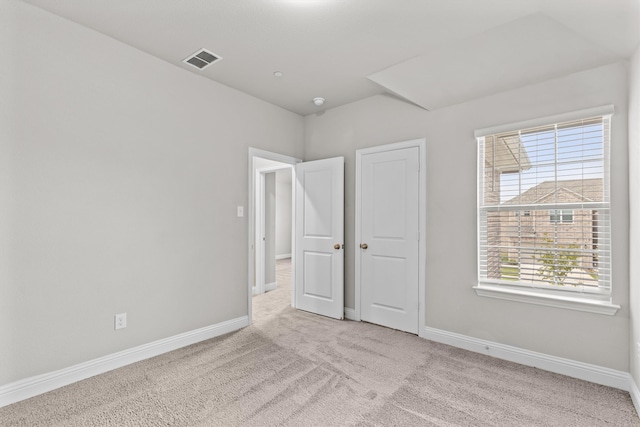 unfurnished bedroom with light colored carpet