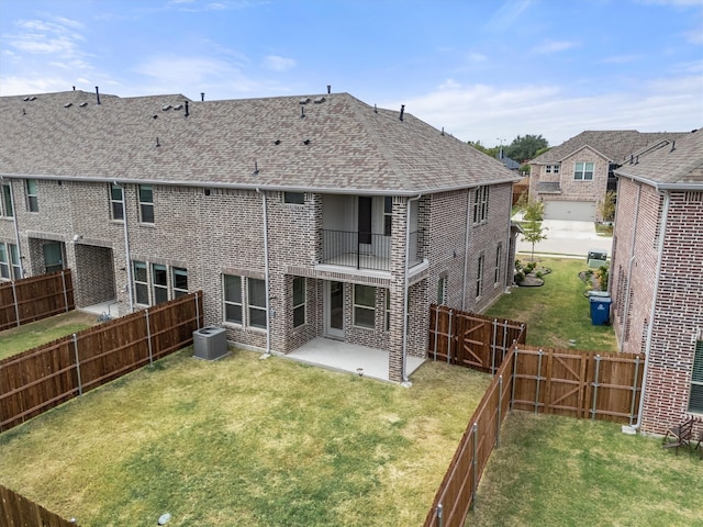 back of property with a lawn, a patio area, a balcony, and central AC unit