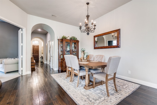 dining room featuring a notable chandelier and dark hardwood / wood-style floors