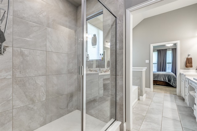 bathroom featuring vanity, tile patterned flooring, lofted ceiling, and walk in shower