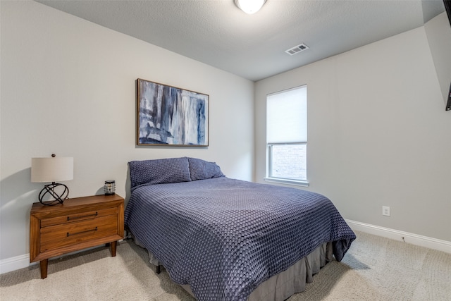 carpeted bedroom with a textured ceiling