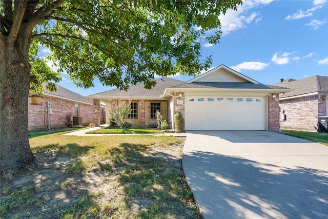 single story home with a front yard, a garage, and central AC unit