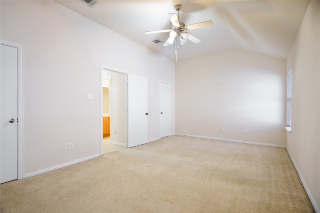 unfurnished bedroom with lofted ceiling, light carpet, and ceiling fan