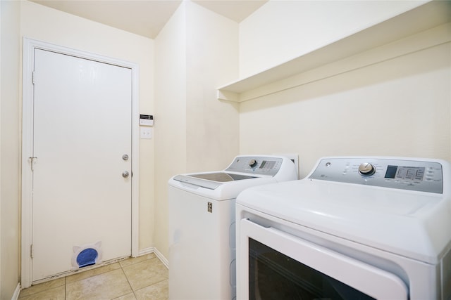 washroom with light tile patterned floors and separate washer and dryer