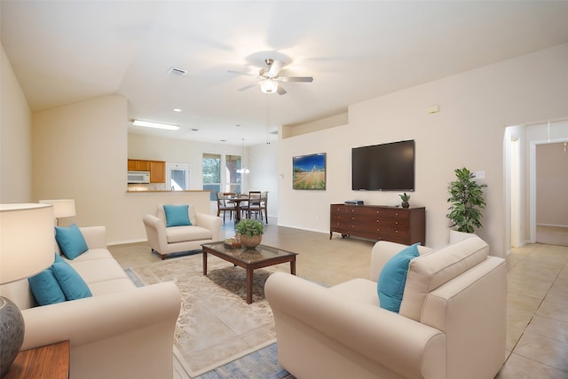 living room with light tile patterned flooring and ceiling fan