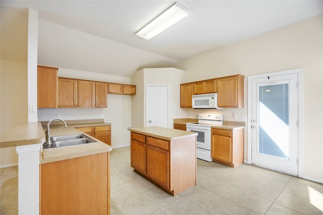 kitchen with white appliances, sink, kitchen peninsula, vaulted ceiling, and light tile patterned floors