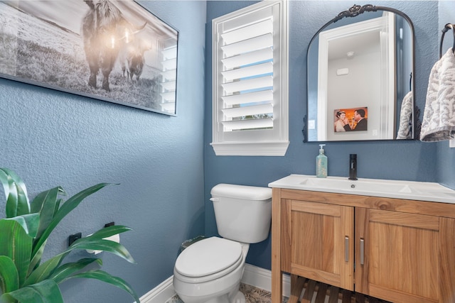 bathroom featuring toilet and vanity