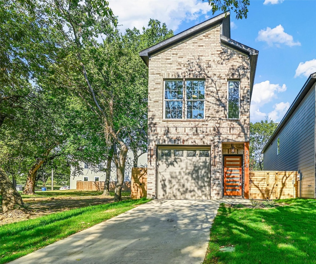 view of front facade featuring an attached garage, driveway, and brick siding