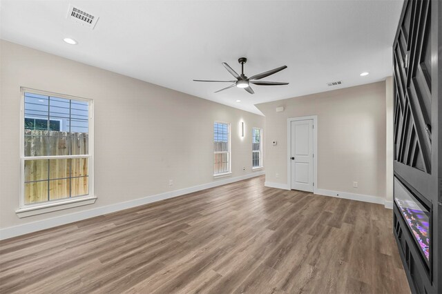 unfurnished living room featuring ceiling fan and light hardwood / wood-style flooring