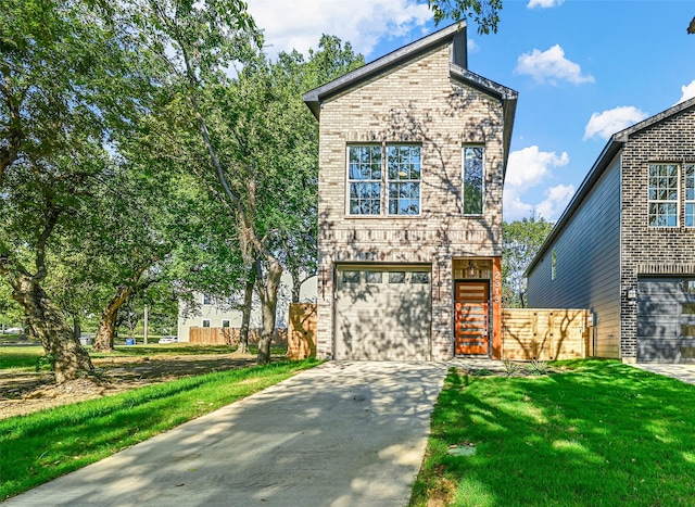 view of front of house featuring a front yard and a garage