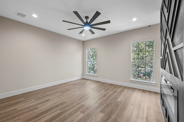 empty room featuring ceiling fan and light hardwood / wood-style flooring