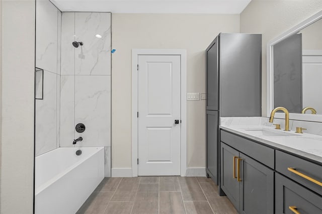 bathroom with tiled shower / bath and vanity