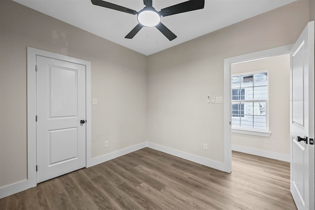 unfurnished room featuring ceiling fan and hardwood / wood-style floors