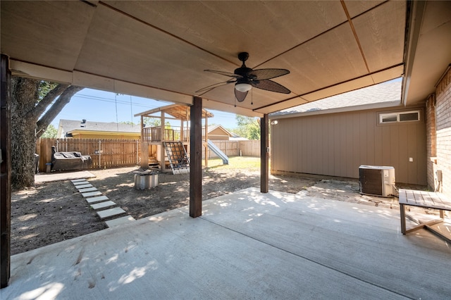 view of patio with ceiling fan, a playground, and central air condition unit