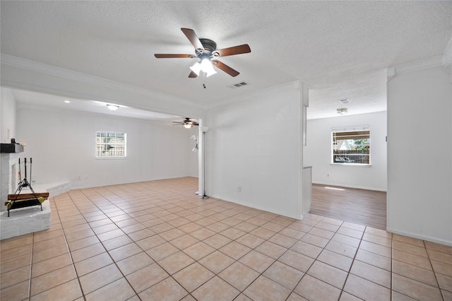 unfurnished living room featuring ornamental molding, a textured ceiling, and ceiling fan