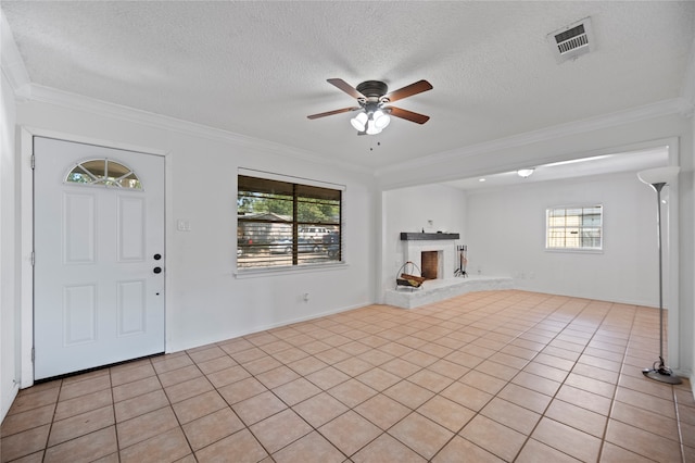 unfurnished living room with a healthy amount of sunlight, light tile patterned flooring, and ornamental molding