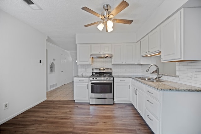 kitchen with stainless steel gas range, sink, dark hardwood / wood-style floors, and white cabinetry