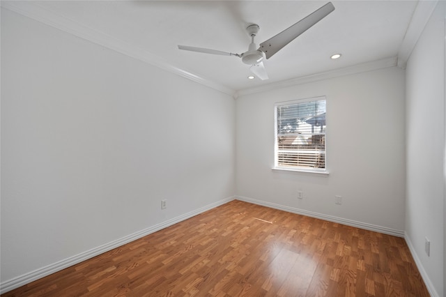 spare room featuring wood-type flooring, ceiling fan, and crown molding