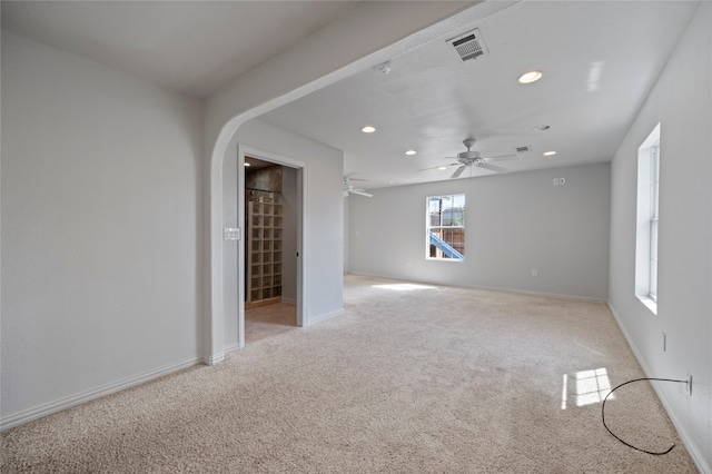 carpeted spare room featuring ceiling fan