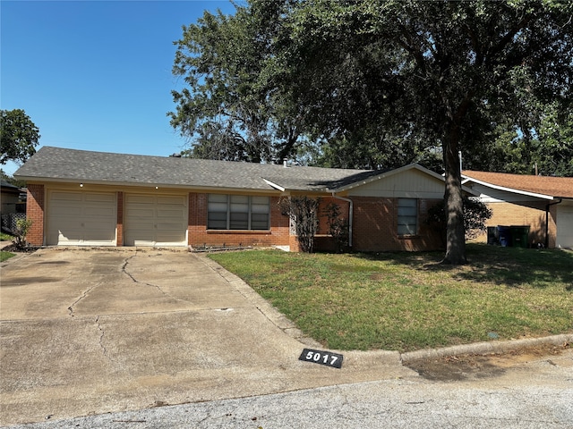 single story home with a front yard and a garage