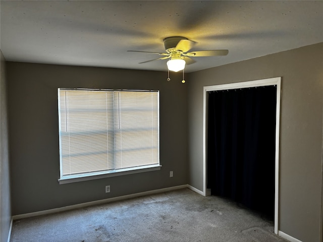 unfurnished bedroom featuring a closet, ceiling fan, and carpet floors