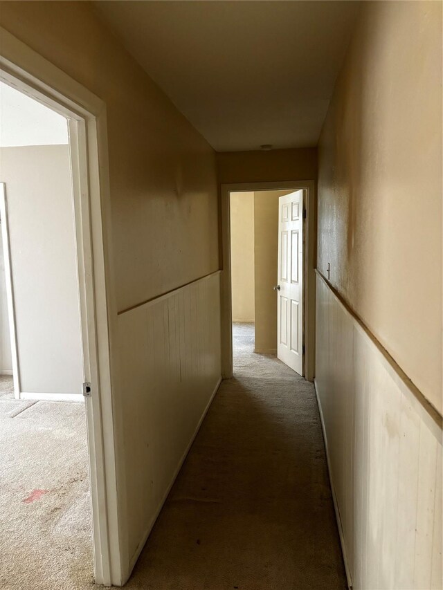 hall featuring light colored carpet