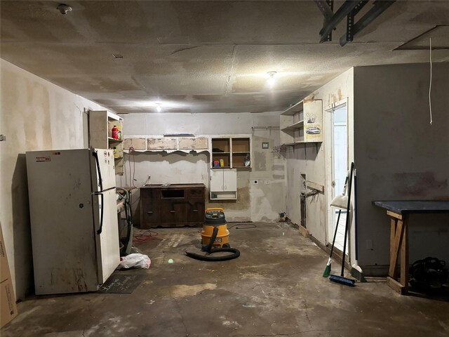 basement featuring white fridge