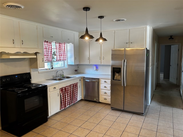 kitchen featuring appliances with stainless steel finishes, white cabinetry, and sink