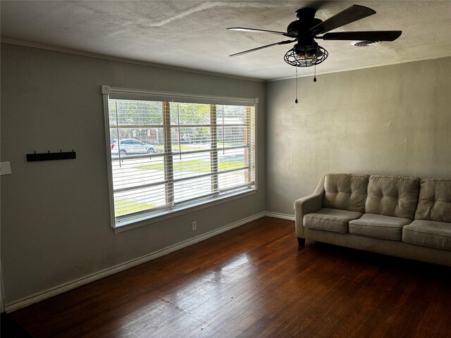 living room with plenty of natural light, ceiling fan, and dark hardwood / wood-style floors