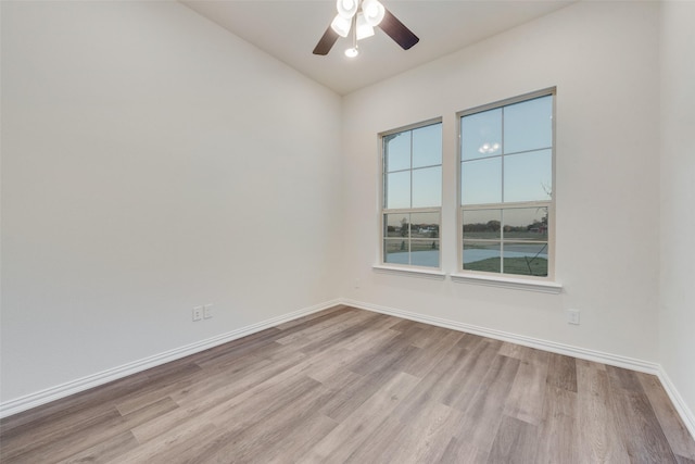 spare room featuring ceiling fan and light hardwood / wood-style flooring