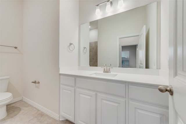 bathroom featuring tile patterned floors, vanity, and toilet