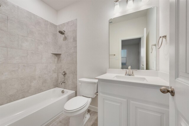 full bathroom featuring vanity, tiled shower / bath combo, and toilet