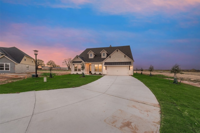 view of front of home featuring a garage and a lawn