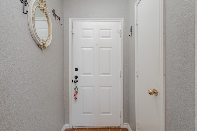 entryway with light tile patterned flooring