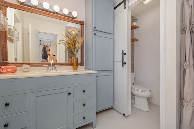 bathroom with tile patterned floors, vanity, and toilet