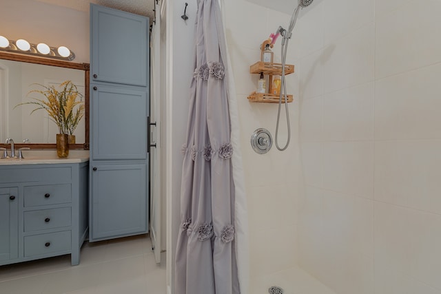 bathroom featuring tile patterned flooring, a shower with curtain, and vanity