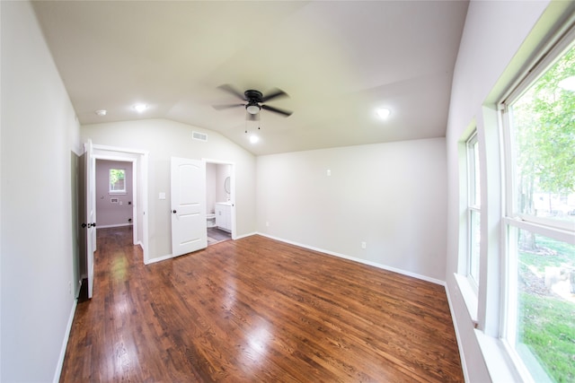 interior space with ceiling fan, dark hardwood / wood-style floors, vaulted ceiling, and a healthy amount of sunlight