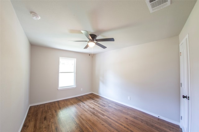 unfurnished room with ceiling fan and dark wood-type flooring