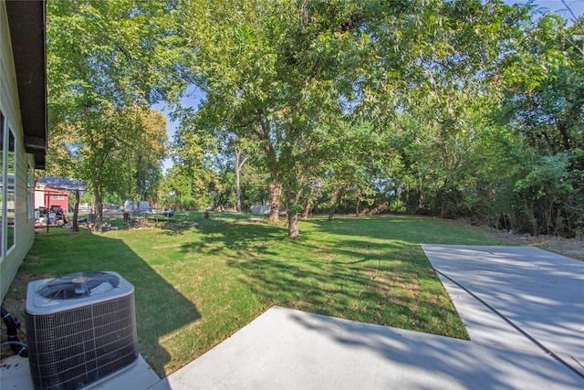 view of yard featuring cooling unit and a patio