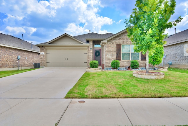 view of front of property featuring cooling unit, a garage, and a front lawn