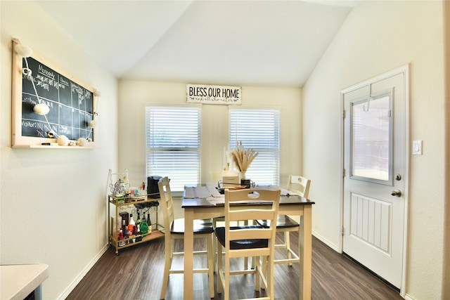 dining space featuring dark hardwood / wood-style flooring and lofted ceiling