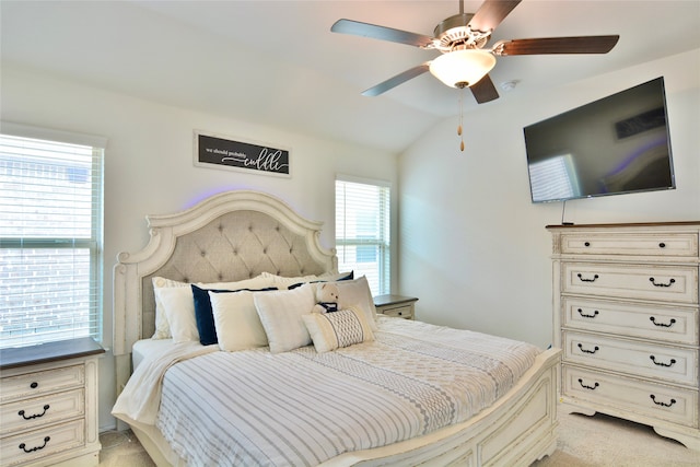 carpeted bedroom featuring lofted ceiling and ceiling fan