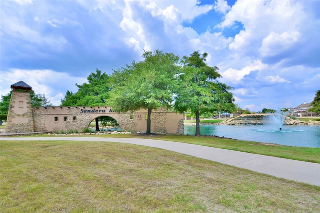 view of home's community featuring a water view and a yard