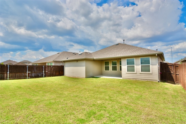 back of property featuring a yard and a patio